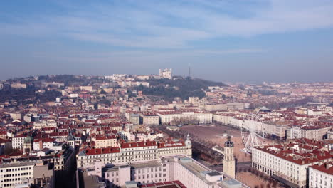 Drone-flying-over-old-Lyon-cityscape-towards-Fourviere-Notre-Dame-hill-viewpoint-on-a-sunny-day
