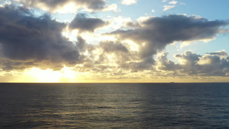 Aerial-drone-shot-flying-towards-a-beautfiul-sunrise-over-the-ocean-near-Bondi-Austraia
