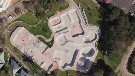 Big-skate-park-with-grass-and-trees-around---top-down-shot