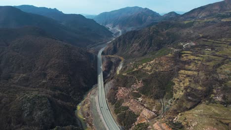 Carretera-Panorámica-Que-Pasa-Por-El-Valle-Del-Río-De-Las-Altas-Montañas-En-Albania,-Vista-Aérea-De-La-Carretera