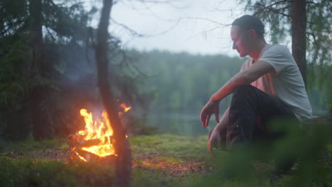 Man-sitting-infront-of-fire-in-the-woods