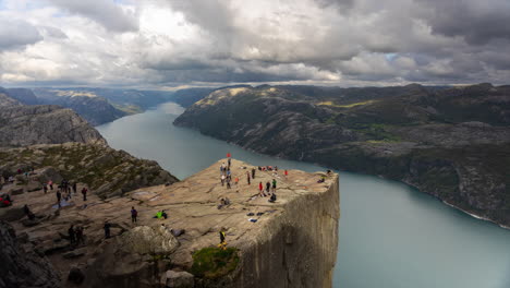 Famous-Preikestolen-in-Lysefjorden,-Norway,-with-changing-light-and-clouds-moving-by