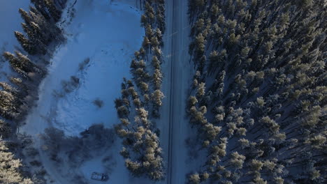 Frozen-winter-landscape-and-icy-road-from-above