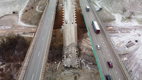 Heavy-A1-highway-traffic-and-demolished-bridge-in-Kaunas,-Lithuania,-aerial-view