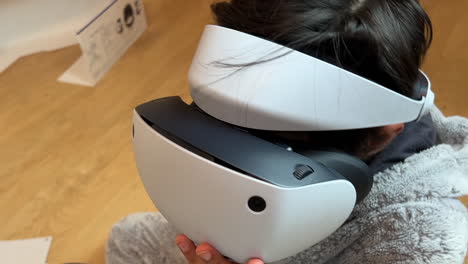 A-boy-unboxing-and-setting-up-the-Sony-PS5-VR2-virtual-reality-headset