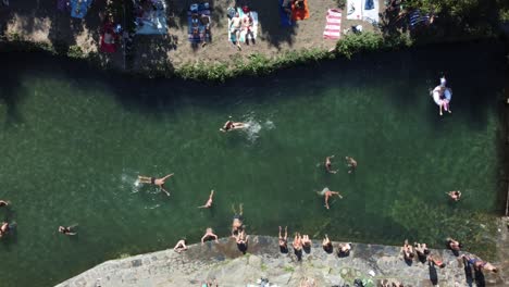 Aerial-topdown-view-of-Natural-river-Beach-crowded-with-people,-Foz-d´Égua