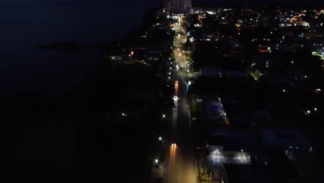 Drone-Shot-of-City-at-Night-with-Cars-and-City-Lights