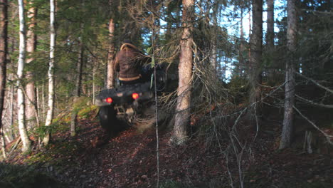 Man-driving-a-ATV-through-the-forrest