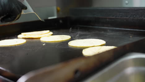 Stacking-the-soft-shell-corn-tortillas-on-the-flat-top-after-grilling---food-taco-series