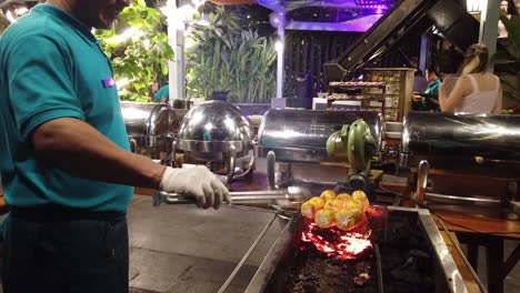 Roasted-Corn-Seller-in-Sanur-Denpasar,-Bali-Indonesia,-Cheff-Cooking-with-Fire-at-Local-Indonesian-Restaurant