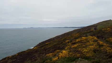 Rising-Drone-Aerial-with-Coastal-Path-Calm-Sea-with-Pembrokeshire-in-the-Distance-UK-4K