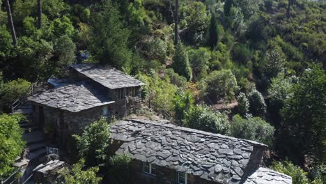 Drone-flyover-suspended-Foz-d´égua-bridge-towards-schist-Houses-in-historic-village