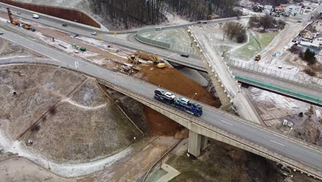 Collapsed-A1-highway-bridge-in-Kaunas-over-Neris-river,-aerial-drone-view-during-snowfall