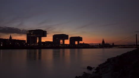 Colorful-day-to-night-timelapse-of-colognes-Crane-Houses-and-rhine-river-in-the-foreground