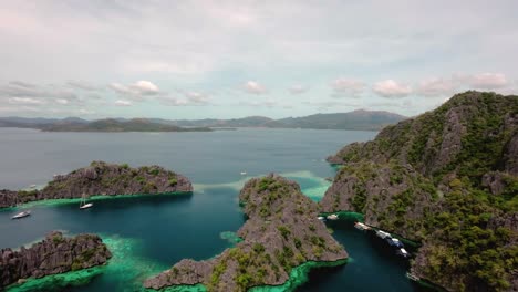 Aerial-view-of-Magical-rock-formation-with-turquoise-colored-sea,-Coron,-Palawan---Philippines