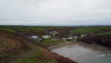 Rising-Drone-Aerial-Shot-of-Nolton-Haven-Pembrokeshire-with-Holiday-Chalets-and-Rural-Road-UK-4K