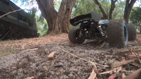 Remote-controlled-truck-doing-burnouts-in-the-dirt-in-slow-motion