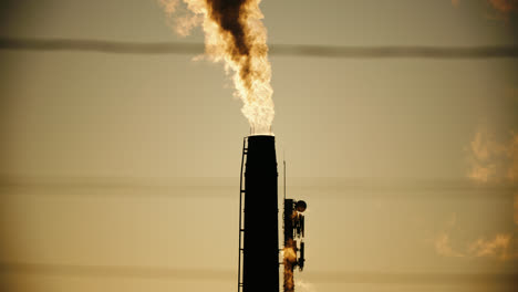 Factory-Chimney-Pipes-Emitting-Air-Pollution-Smoke-into-Atmosphere-during-Sunset
