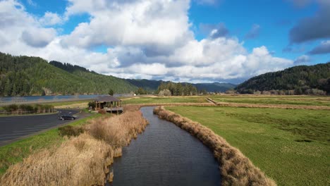 4K-aerial-drone-shot-gliding-above-water-at-Dean-Creek-in-Reedsport,-Oregon