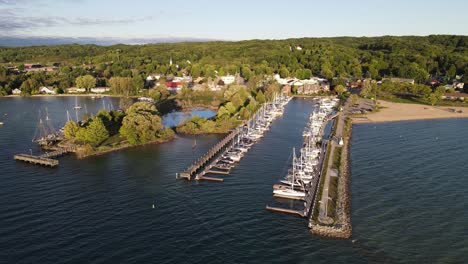 Small-pier-of-Suttons-Bay-with-private-sail-boats,-aerial-drone-view