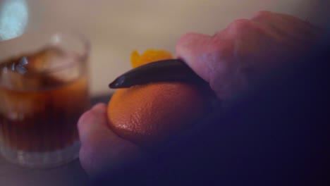 Preparing-a-martini-cocktail,-rum,-orange-and-ice