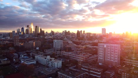 Drone-shot-flying-and-panning-across-London-city-skyline-at-sunset