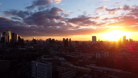 Aerial-view-London-city-skyline-silhouetted-at-beautiful-sunset,-UK