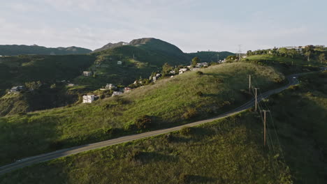 Aerial-drone-shot-flies-over-Malibu-mountain-to-reveal-houses-and-mansions-in-the-hills