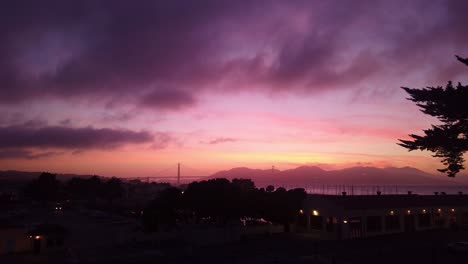 Gimbal-panning-shot-of-the-Golden-Gate-Bridge-from-Fort-Mason-at-twilight-with-a-colorful-pink-and-purple-sky-in-San-Francisco,-California