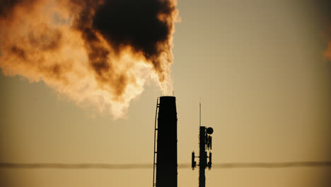 Industrial-Factory-Pipes-Silhouette-Emitting-Thick-Toxic-Smoke-into-Atmosphere