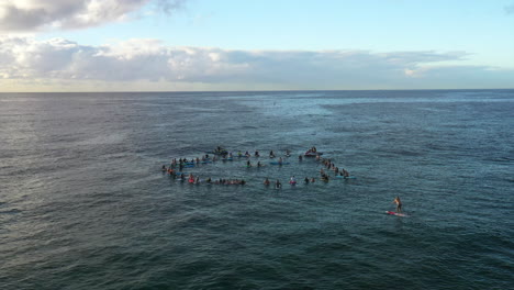 A-group-of-people-hold-a-paddle-out-memorial-ceremony-on-the-water-in-Bondi-Australia