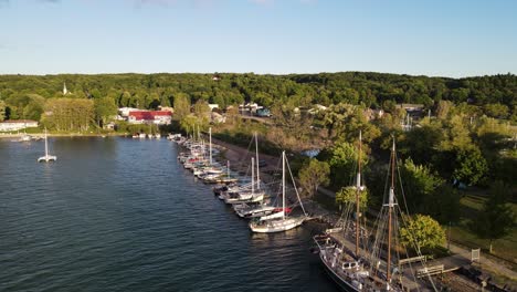 Suttons-Bay-with-moored-boats-in-Michigan,-USA,-aerial-drone-ascend-view