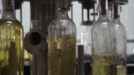 White-wine-bottling-line-with-bottles-turn-in-and-filling