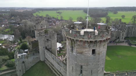 Rising-drone-aerial-Warwick-Castle-tower-Warwickshire-English-flag-reveal