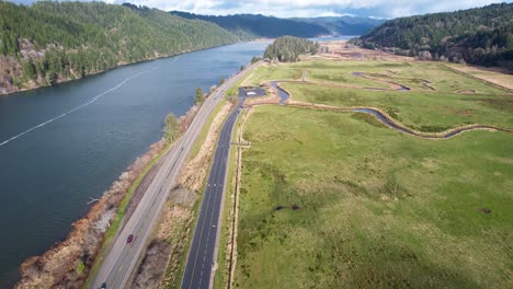 4K-aerial-drone-shot-gliding-over-road-in-Reedsport,-Oregon