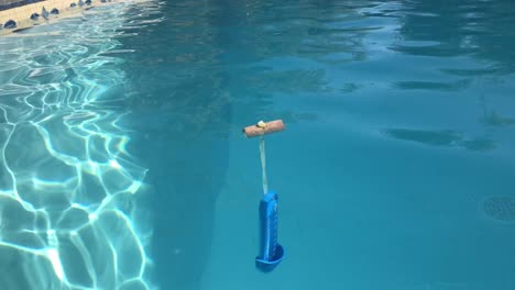 Ground-level-close-up-view-of-floating-swimming-pool-thermometer