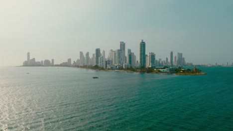 Drone-shot-of-the-city-in-the-ocean-getting-closer,-Colombia,-Cartagena