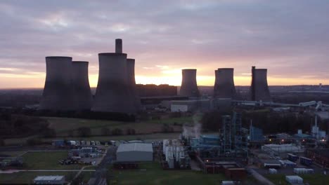 Fiddlers-Ferry-disused-coal-fired-power-station-at-sunrise,-Aerial-view-behind-landmark,-Push-in-shot