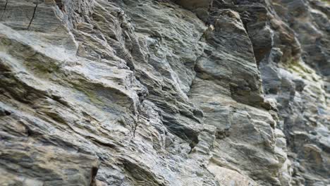 Close-up-video-rocks-cliff-tilt-up