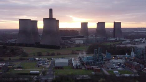 Aerial-view-over-Fiddlers-Ferry-disused-coal-fired-power-station-with-sunrise-glowing-behind-landmark