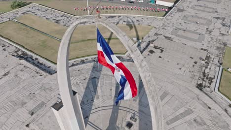 High-angle-and-Slow-motion-of-Dominican-Republic-flag-waving-over-triumphal-arch-in-plaza-de-la-Bandera,-Santo-Domingo