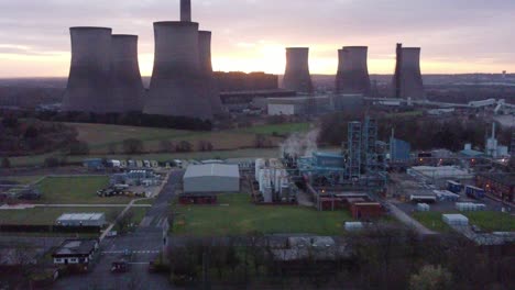 Fiddlers-Ferry-disused-coal-fired-power-station-with-sunrise-behind-Warrington-landmark,-Aerial-view-establishing-shot