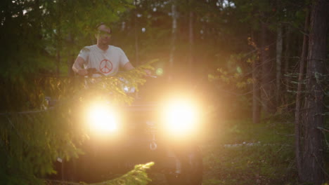 Man-driving-a-ATV-through-the-forest