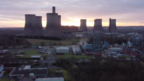 Fiddlers-Ferry-disused-coal-fired-power-station-at-sunrise-skyline-behind-Warrington-landmark-Aerial-view-pulling-back