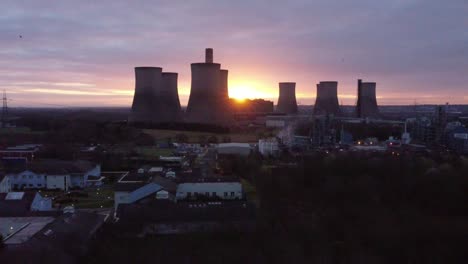 Fiddlers-Ferry-disused-coal-fired-power-station,-Aerial-view-sunrise-disappears-behind-landmark