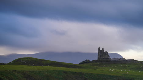 Timelapse-of-Classiebawn-Castle-on-grassland-coastline-with-moving-sunset-evening-clouds-in-Mullaghmore-Head-in-county-Sligo-on-the-Wild-Atlantic-Way-in-Ireland
