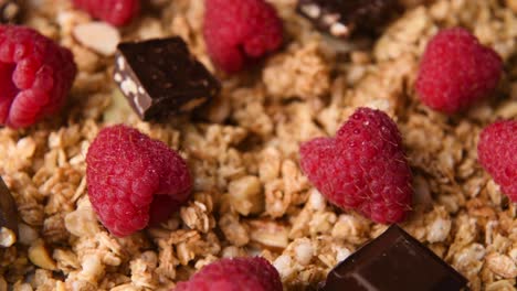 Detail-close-up-shot-of-granola-with-chocolate-and-raspberries