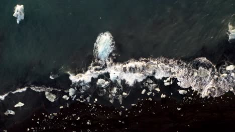 Top-Down-View-Of-Icebergs-On-Diamond-Beach-In-Iceland---drone-shot