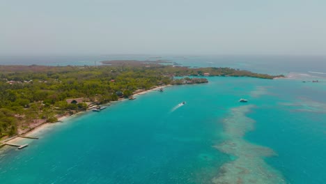 Aerial-drone-shot-of-Isla-grande,-big-island-in-colombia-with-the-clear-ocean,-cartagena