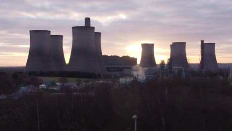 Fiddlers-Ferry-disused-power-station-at-sunrise,-Aerial-view-over-treetops